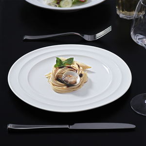 White porcelain plate set restaurant table elegant dining presentation