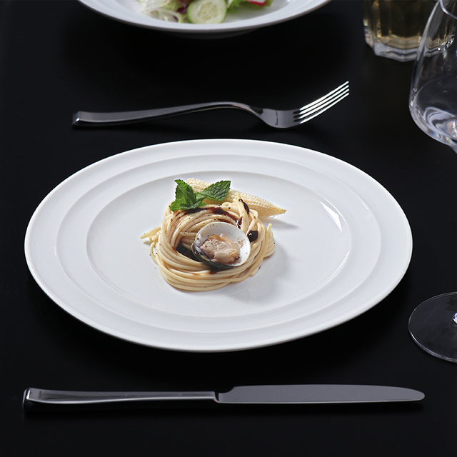 White porcelain plate set restaurant table elegant dining presentation