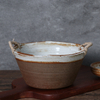 Rustic ceramic bowl with handle glazed texture detail