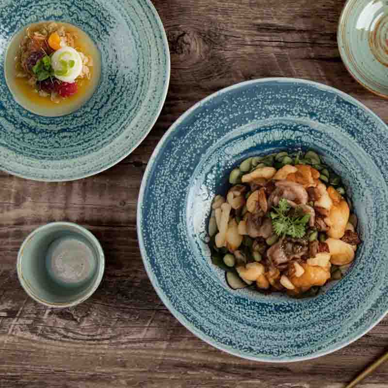 Close-up of the reinforced rolled rim on durable ceramic tableware to resist edge chipping in restaurants